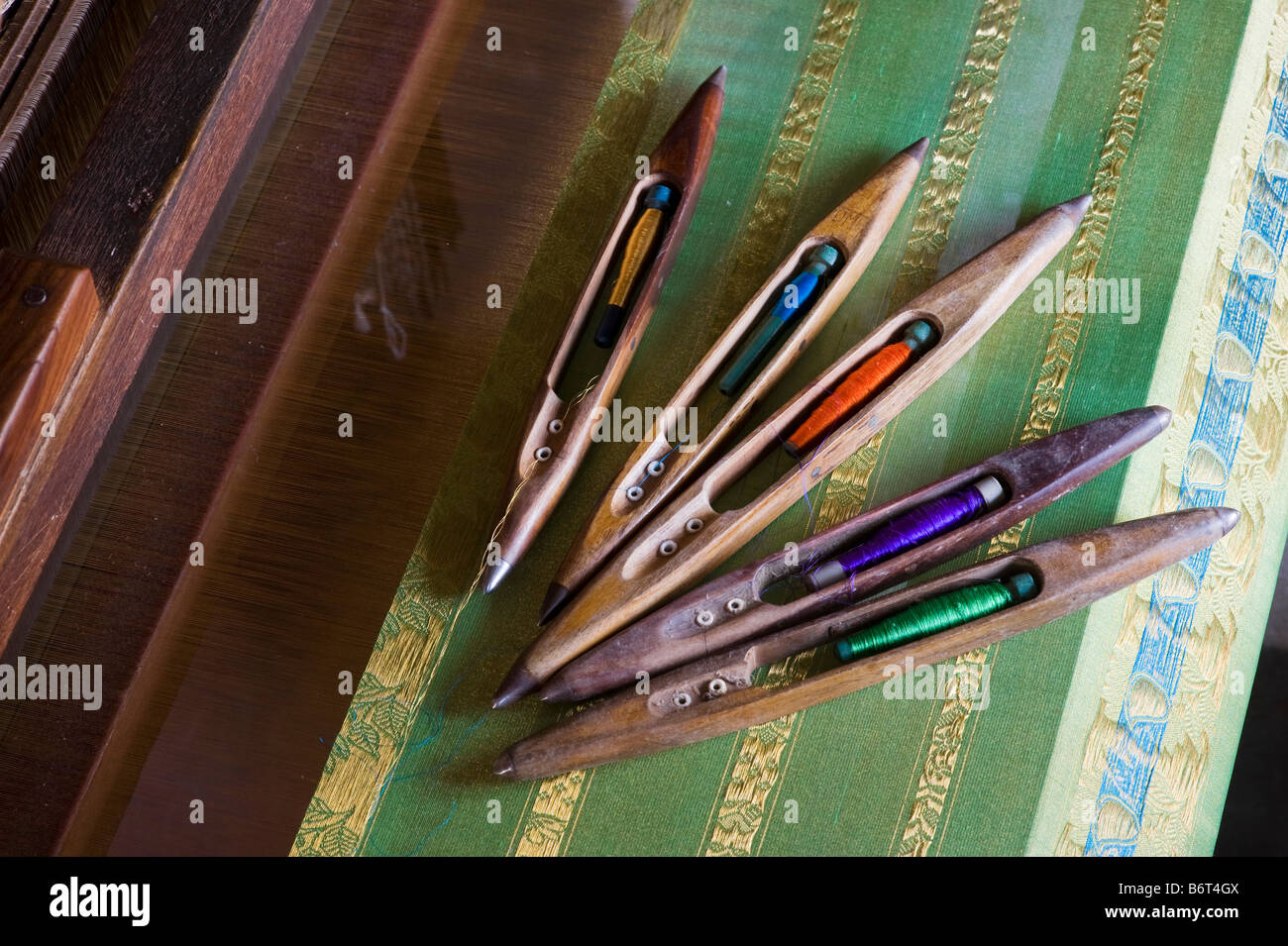 Hand loom, silk bobbins and finished silk sari on a hand loom in a rural Indian village house. Andhra Pradesh, India Stock Photo