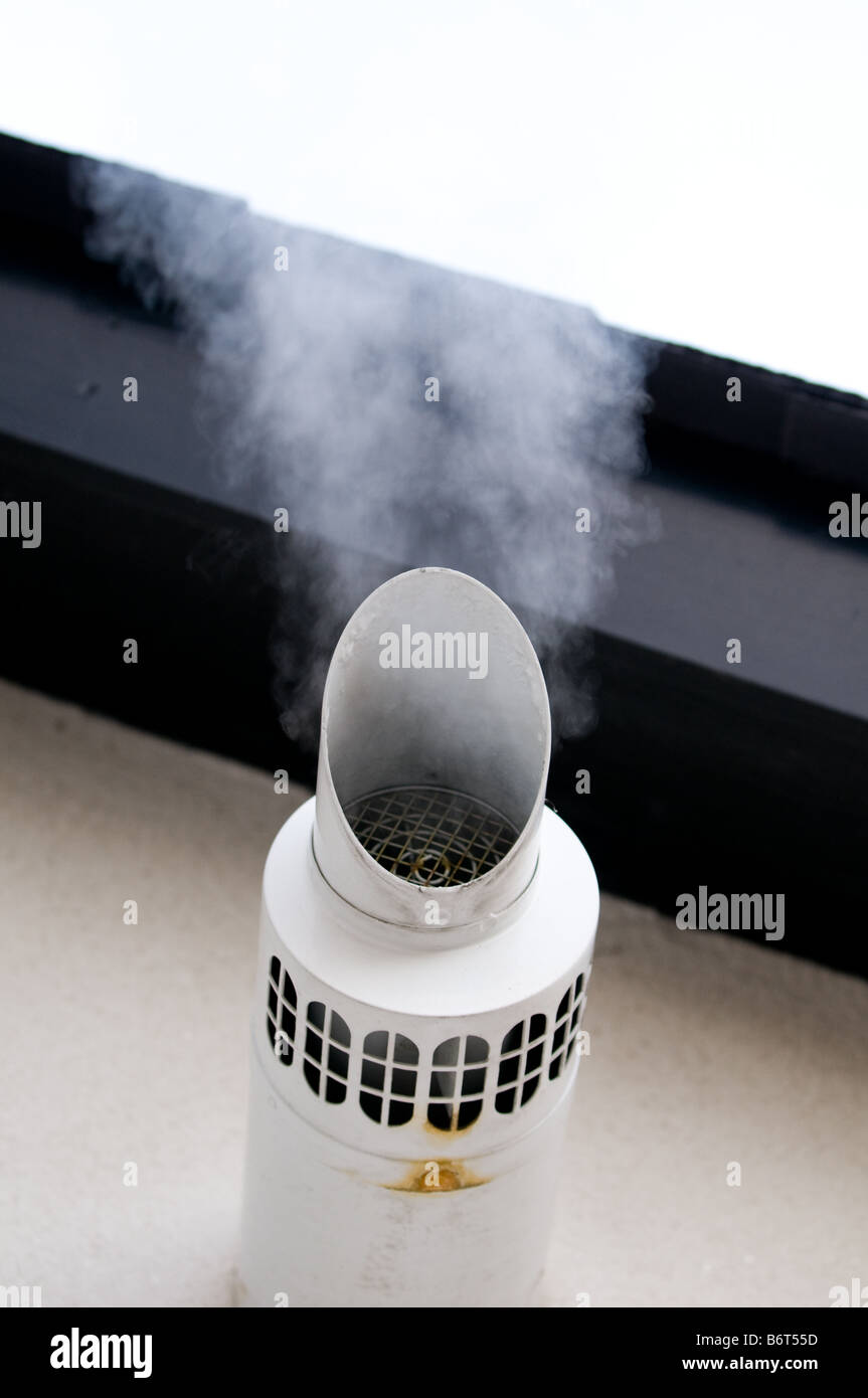 Steam emerging from the outlet flue of an industrial central heating system in winter Stock Photo