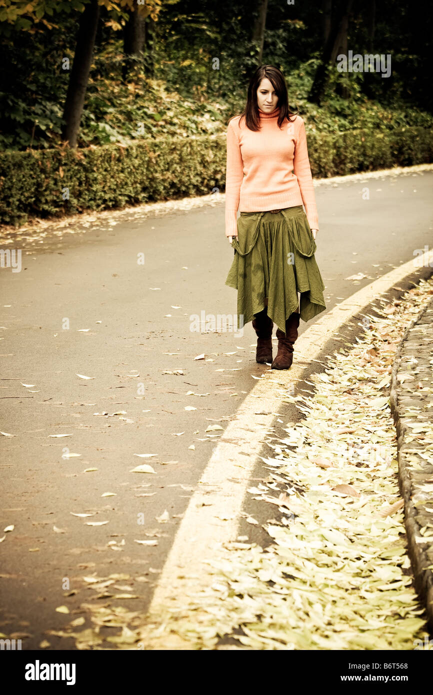 Young woman taking a walk by the road Stock Photo - Alamy