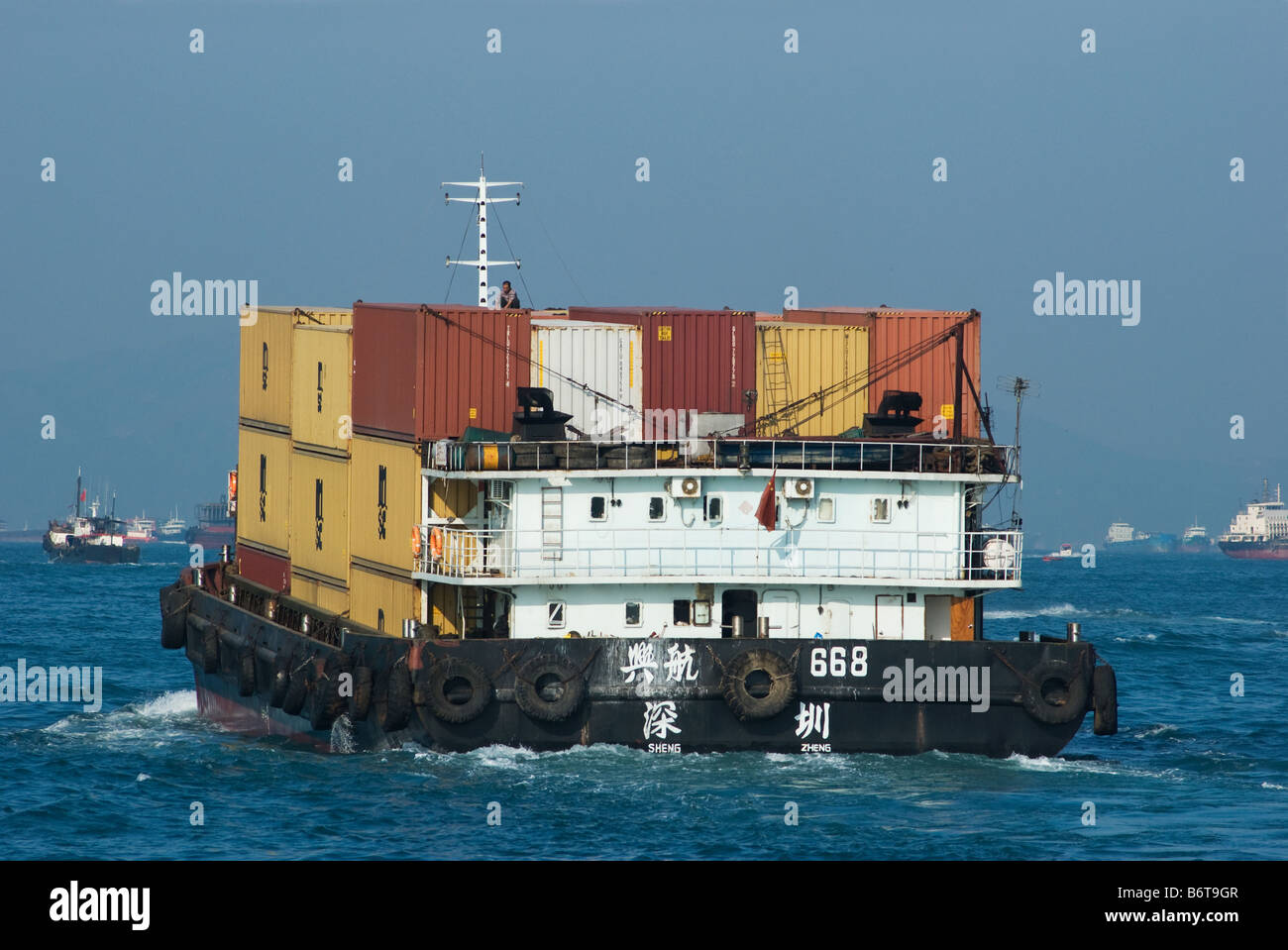 Chinese container feeder vessel in the harbour of Hong Kong Stock Photo