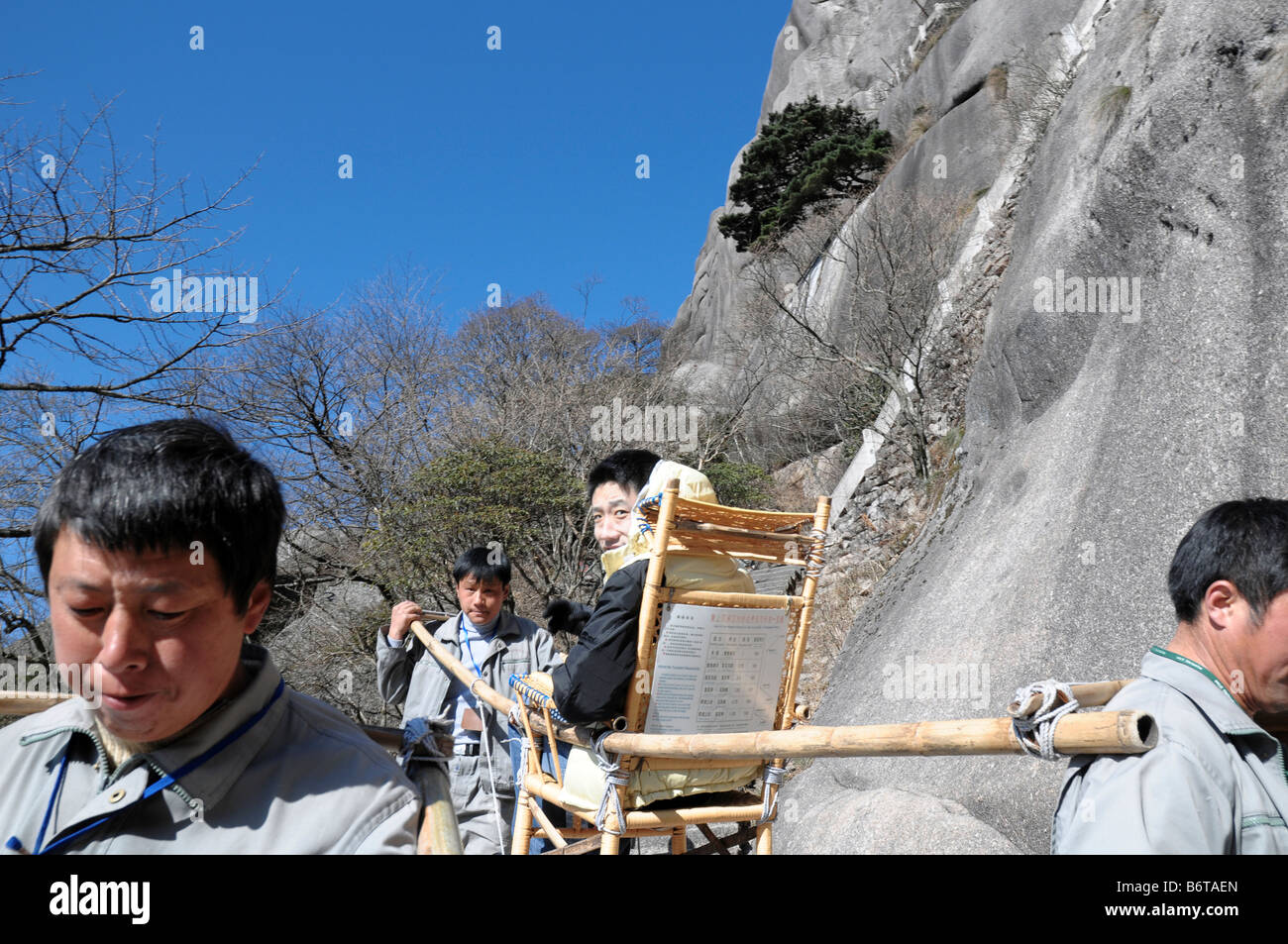 Sedan chairs on Huangshan, Yellow Mountain Geopark, Anhui, China. Visitors can pay to be carried up and down the mountains. Stock Photo
