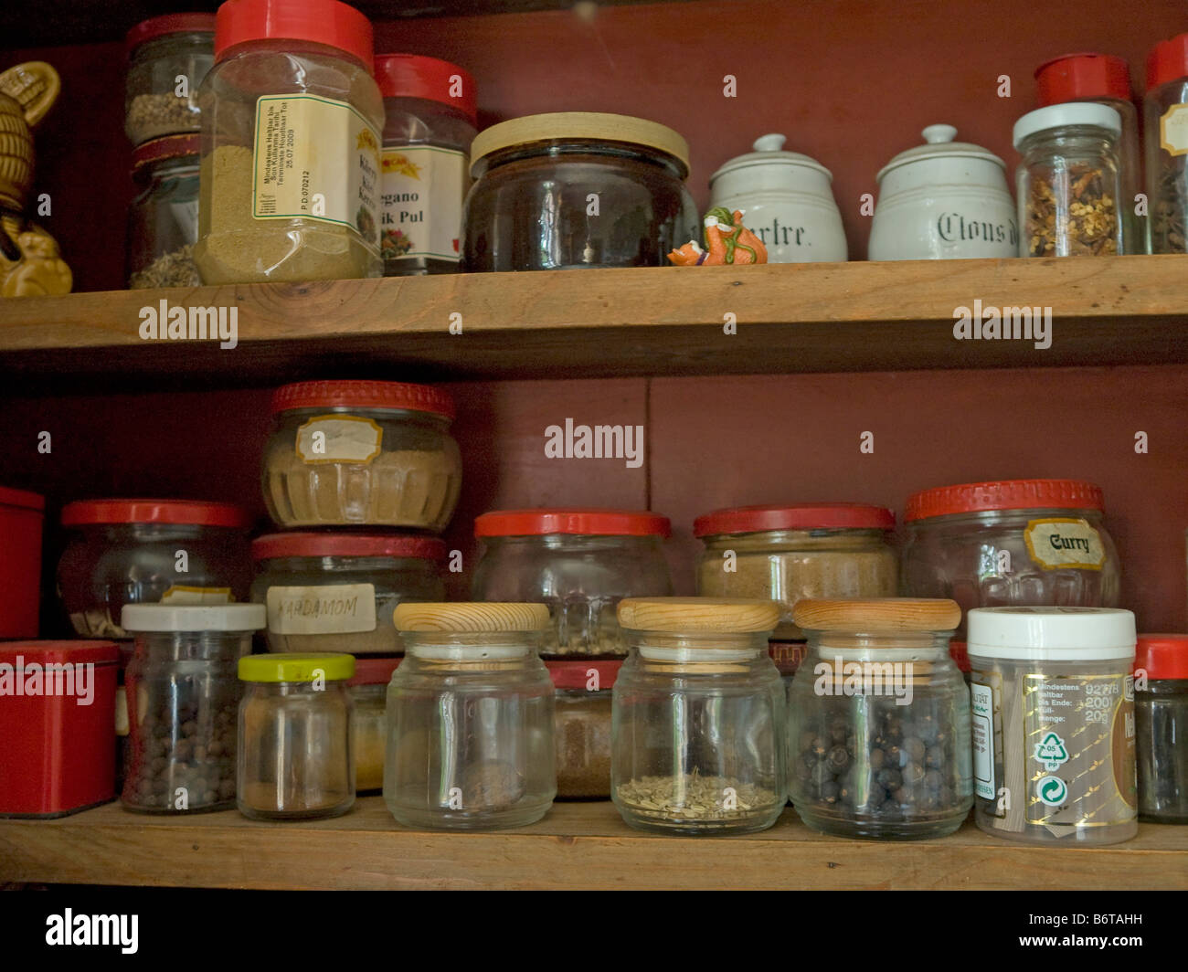 Wooden Kitchen Cupboard With Different Glasses And Pots With