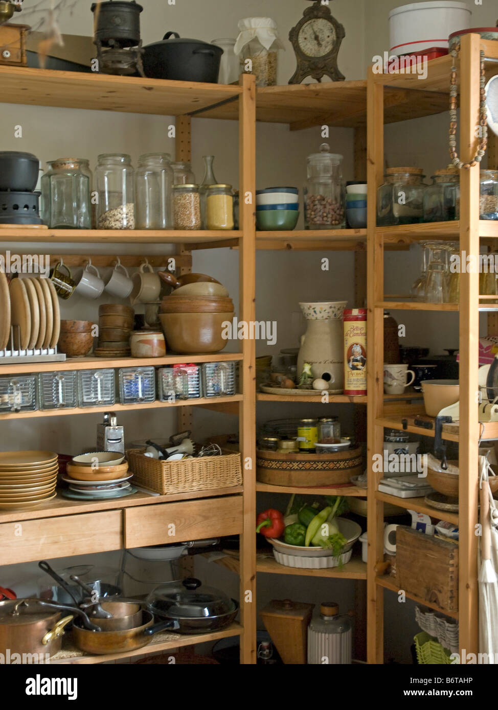 wooden kitchen cupboard with crockery dishes and pottery Stock Photo Alamy