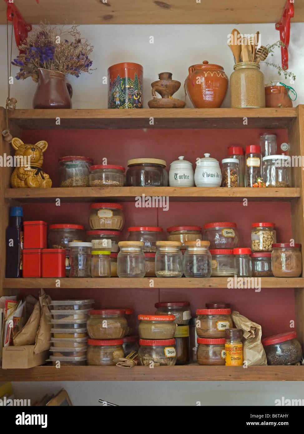 Wooden Kitchen Cupboard With Different Glasses And Pots With