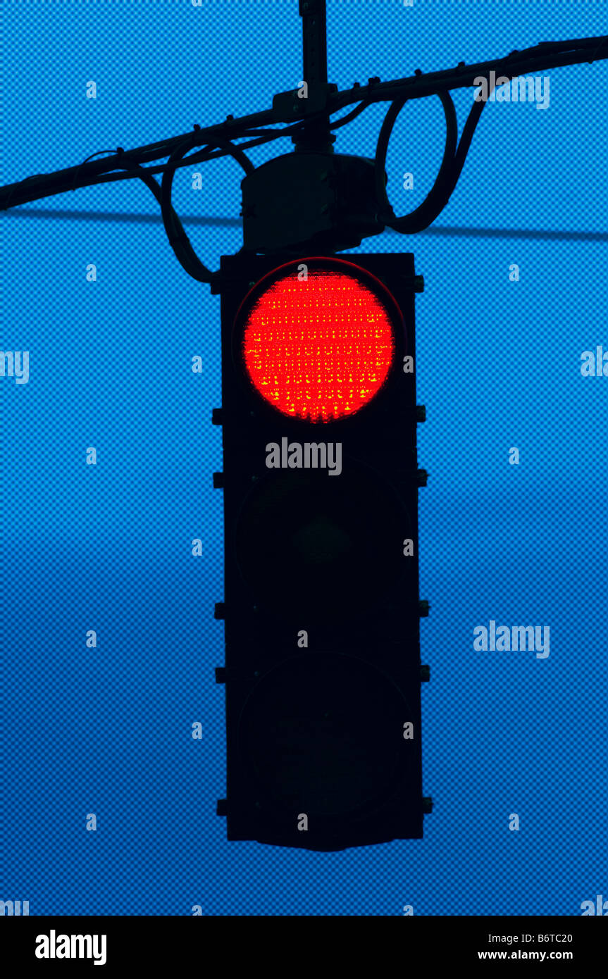 digitally altered red traffic stop light at night Stock Photo