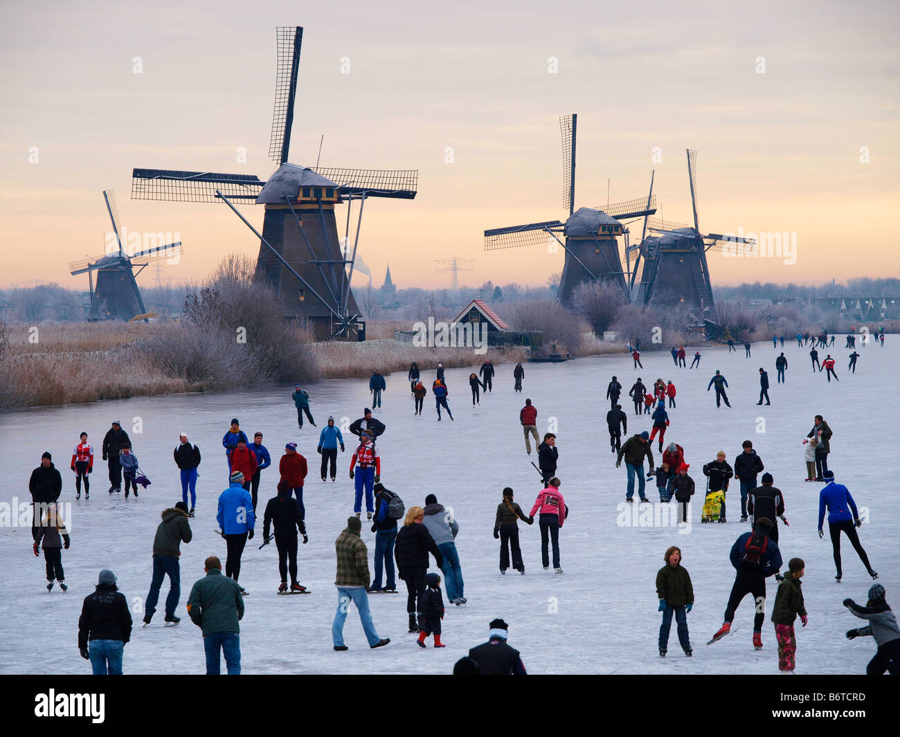 Winter in Holland many people skating on natural ice Kinderdijk windmills the Netherlands Stock Photo