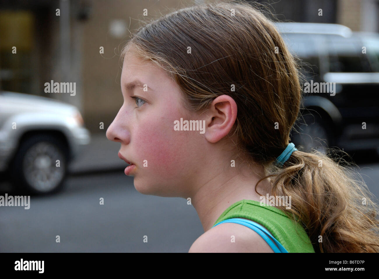 close view of a pretty tween girl with fresh coloring colouring on a New York City street in spring Stock Photo