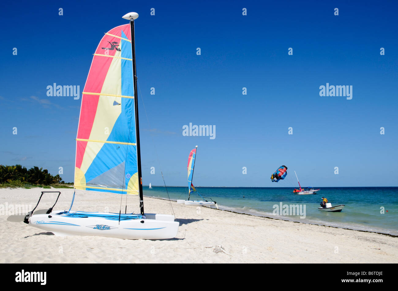 A catamaran sits on the white sandy beach at Playa Mujeres, north of Cancun, Quintana Roo, Mexico Stock Photo
