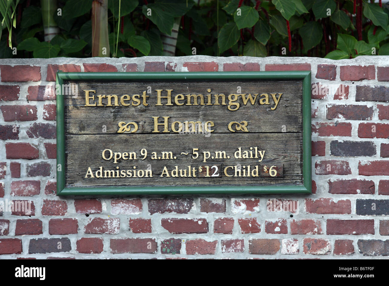 Wooden welcome sign on brick wall at the Ernest Hemingway Home in Key West Florida Stock Photo