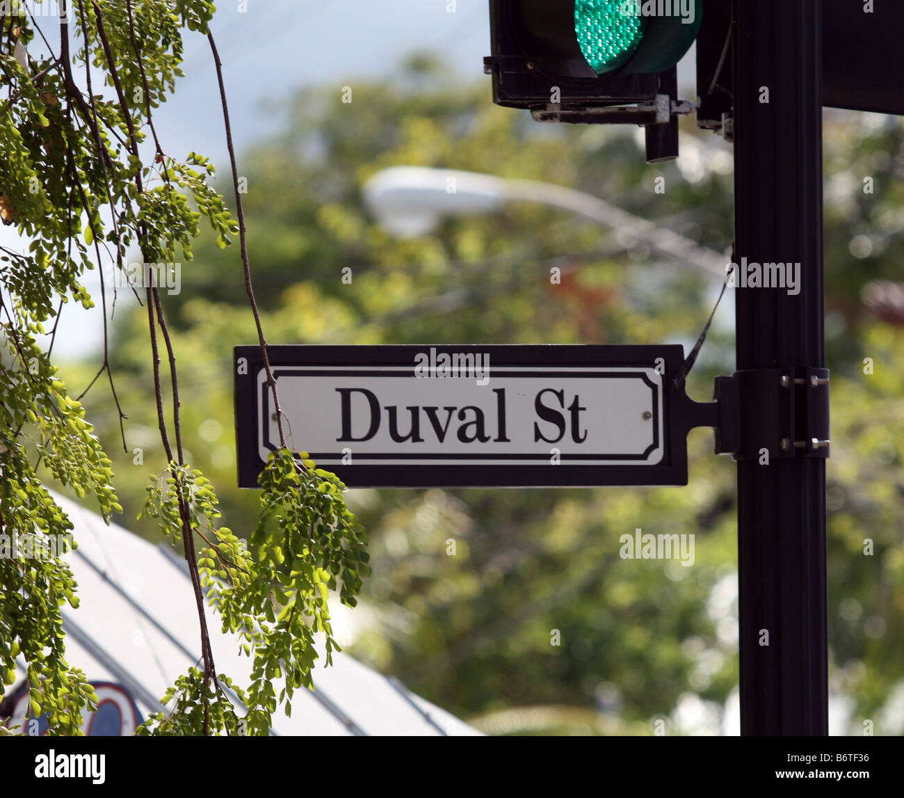 Duval St sign on signpost with green traffic signal in Key West Florida Stock Photo