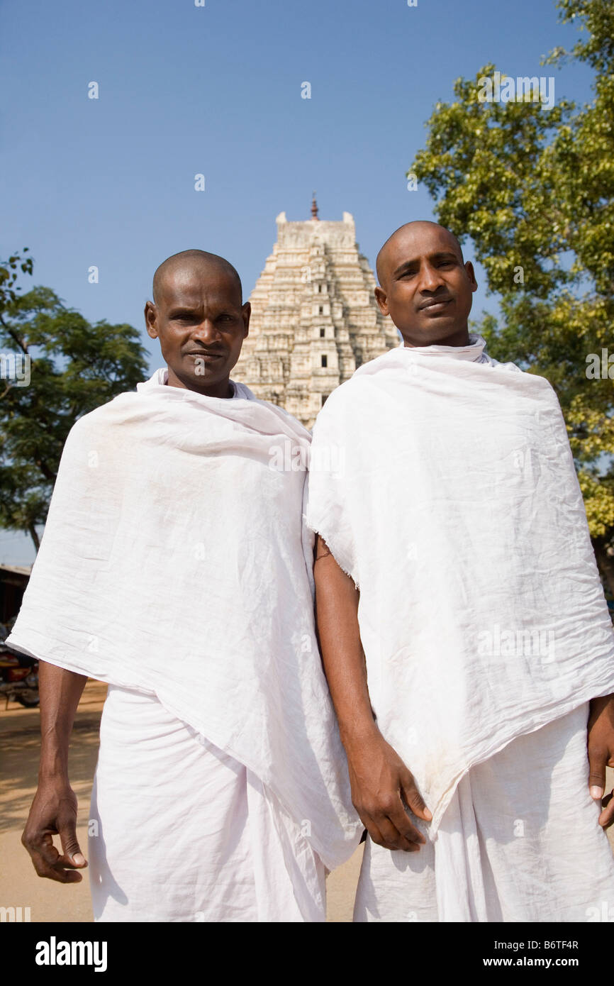 Two sadhus in front of a temple, Virupaksha Temple, Hampi, Karnataka, India Stock Photo