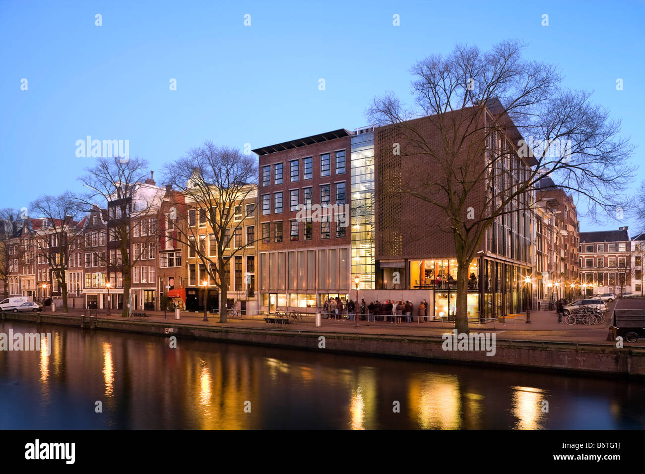 Anne Frank Huis, House and Museum on the Prinsengracht Canal in Amsterdam, the Netherlands; Holland. At dusk in winter. Stock Photo