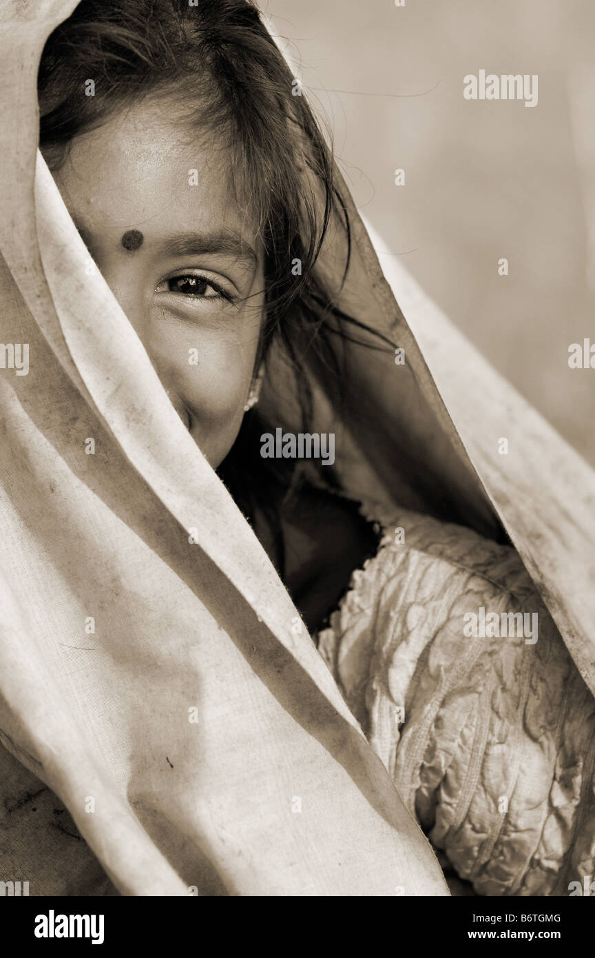 Poor nomadic indian girl wrapped in a dirty sheet. Portrait. Andhra Pradesh, India Stock Photo