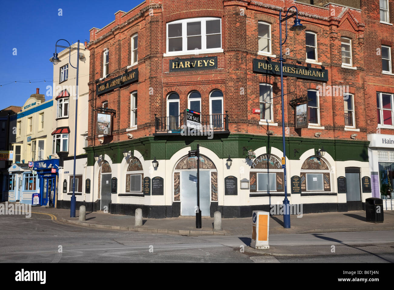 A closed and boarded up pub on the harbourside at Ramsgate, symptom of