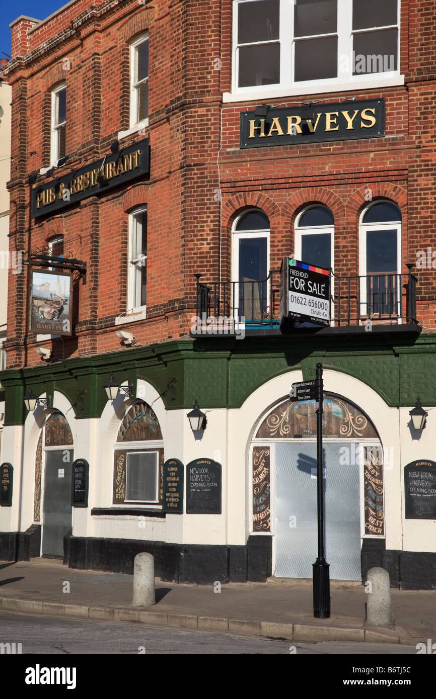 A closed and boarded up pub on the harbourside at Ramsgate, symptom of