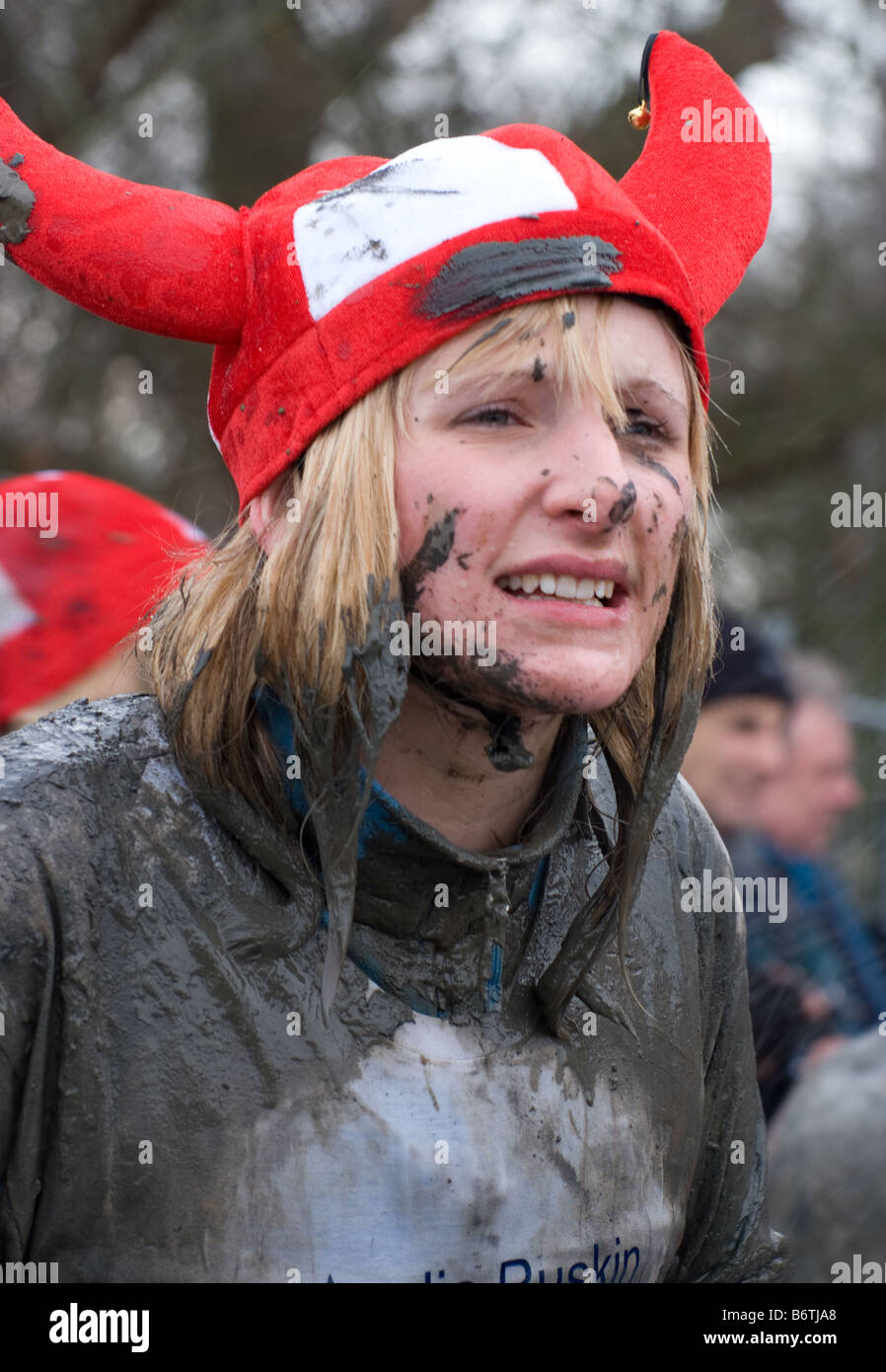 a female fun runner shivers in the cold , after competing in the 2009 maldon mud race Stock Photo