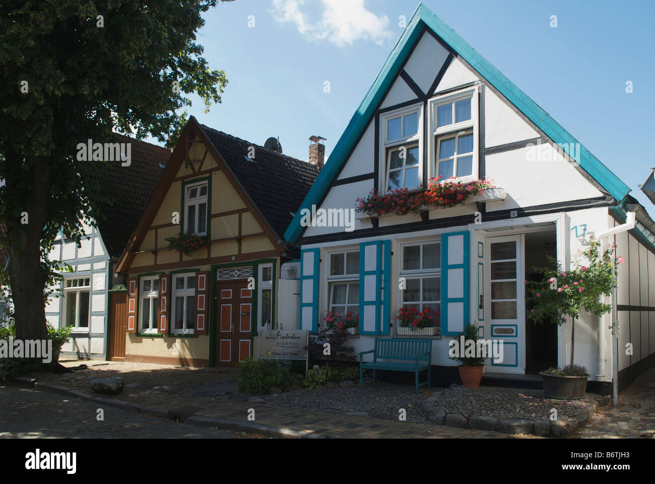 Pretty row of houses and Bed and Breakfast guesthouses in quiet Alexandrinenstrasse Warnemunde Germany Stock Photo