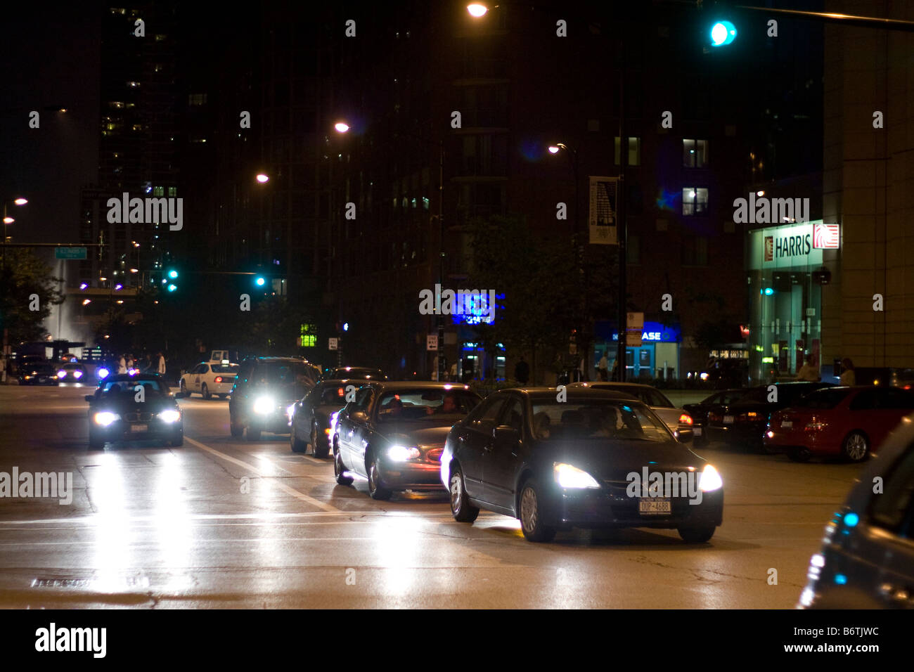 Cars driving at night in Chicago near Illinois Ave Stock Photo