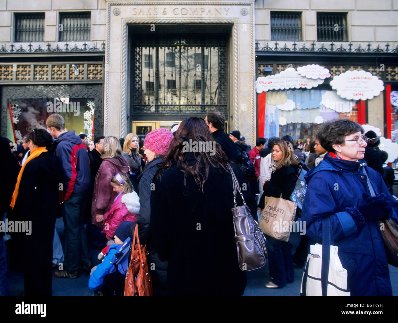 New York City Christmas shoppers on a crowded Fifth Avenue. Busy street scene in front of Saks Fifth Avenue store. USA Stock Photo