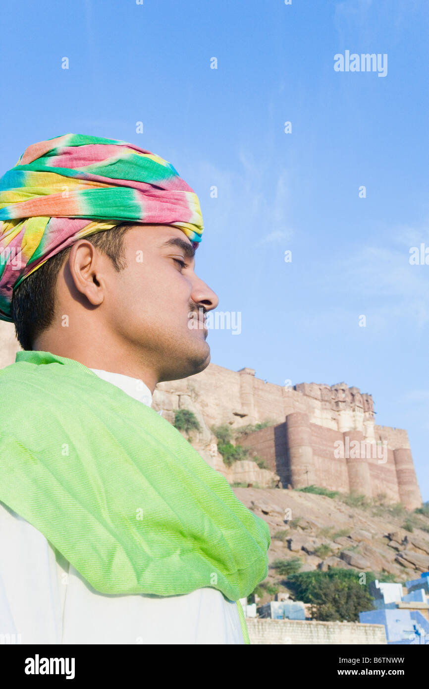 Side profile of a man with fort in the background, Meherangarh Fort, Jodhpur, Rajasthan, India Stock Photo