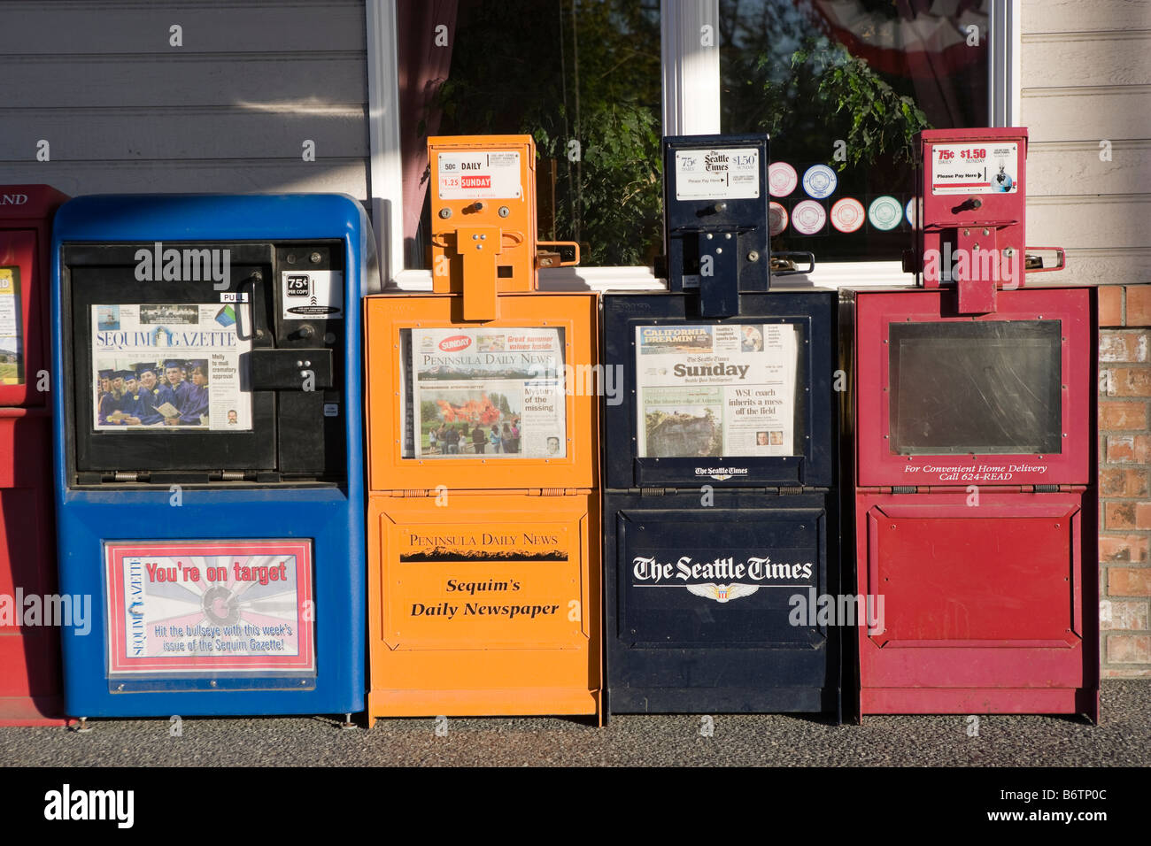 A rack of coin operated American newspaper dispensers, Coin Op News