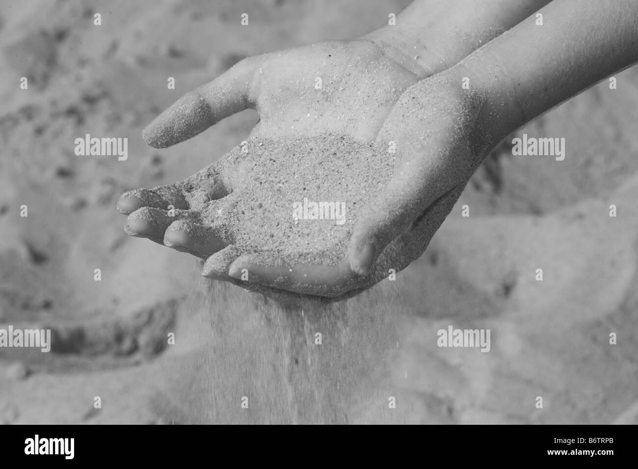 Sand slipping through hands Black and White Stock Photos & Images Alamy