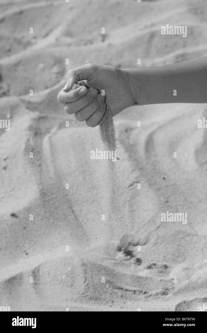 Grains of sand slipping through a childs hands at beach Stock Photo Alamy
