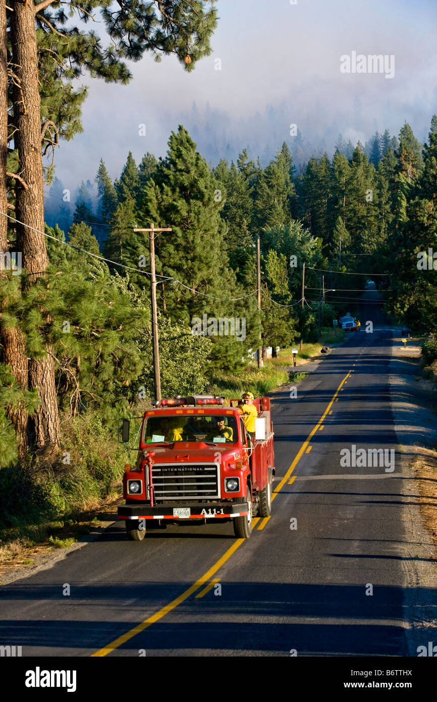 Firefighting truck driving up road near a wildfire near Spokane, Washington, USA Stock Photo