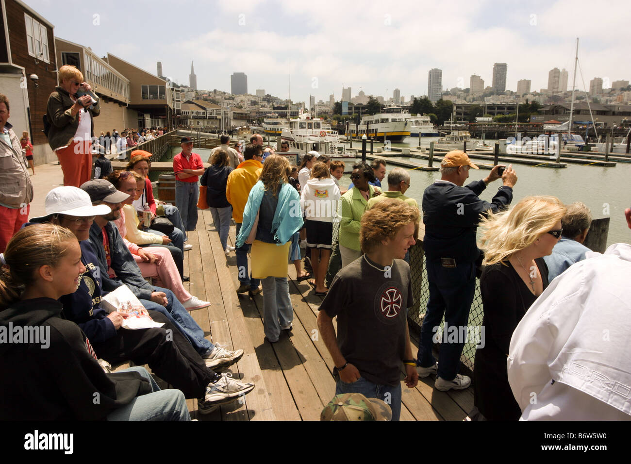 Tourists enjoying the view across San Francisco from Pier 39, California USA Stock Photo