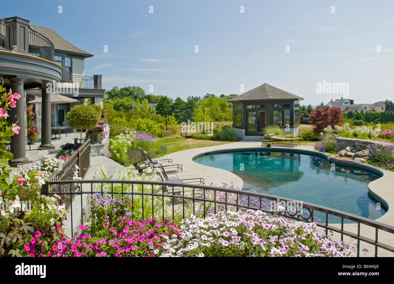 Rear exterior large neo eclectic home with swimming pool Stock Photo