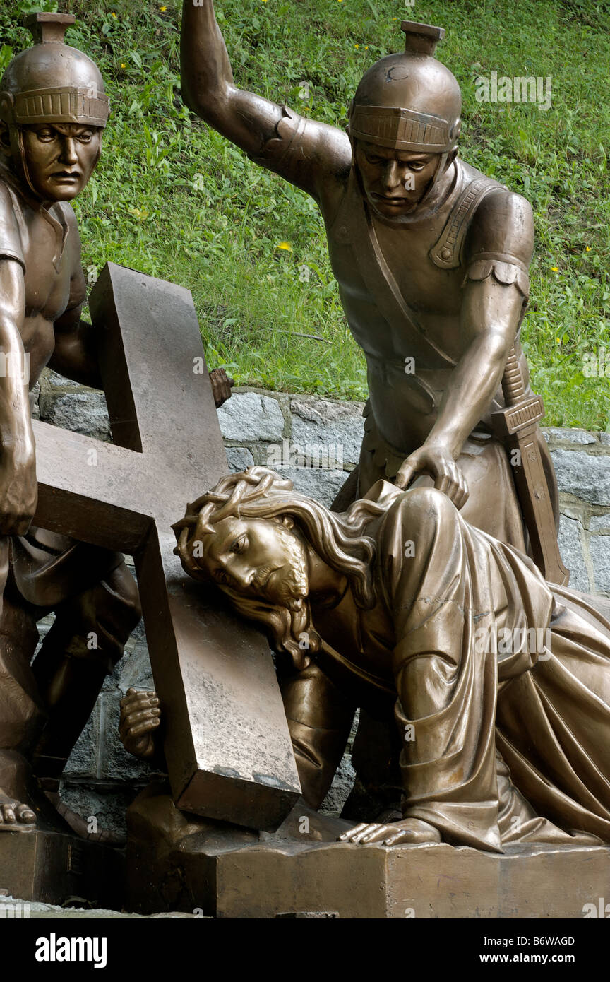 Jesus on the ground being whipped by a roman soldier from the stations of the cross Stock Photo