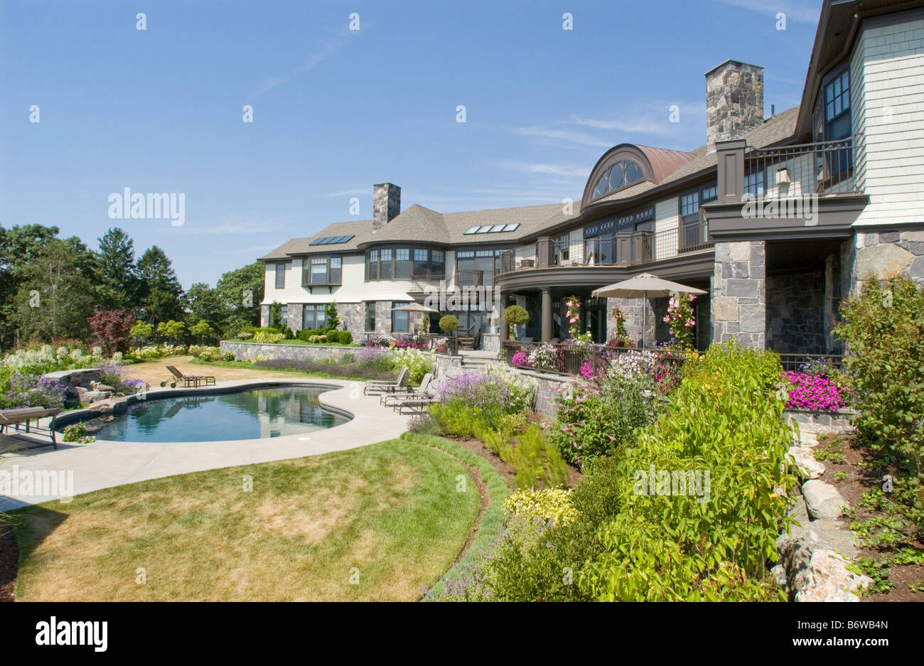 Rear exterior large neo eclectic home with swimming pool Stock Photo