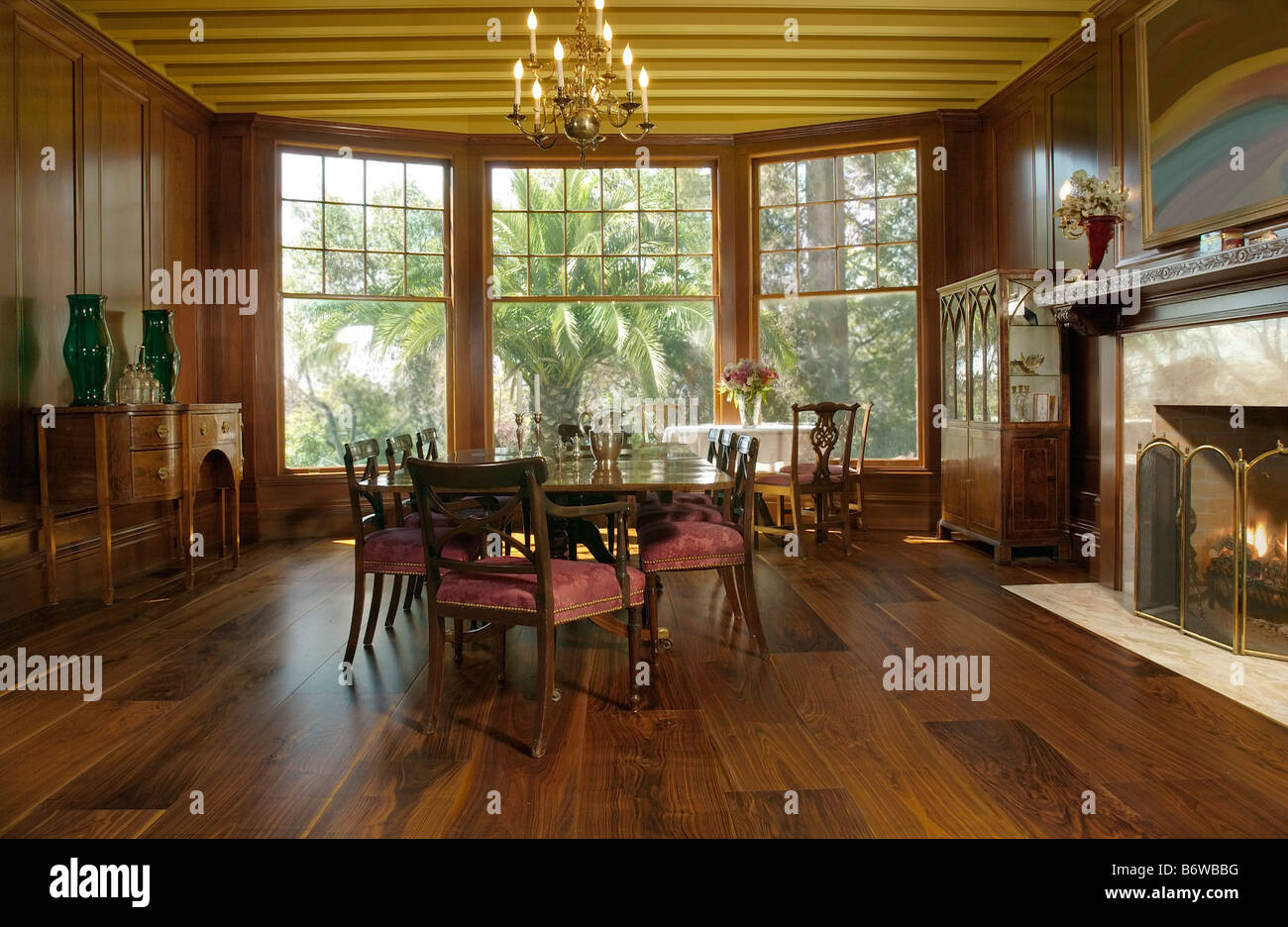 Elegant dining room with bay windows and fireplace Stock Photo Alamy