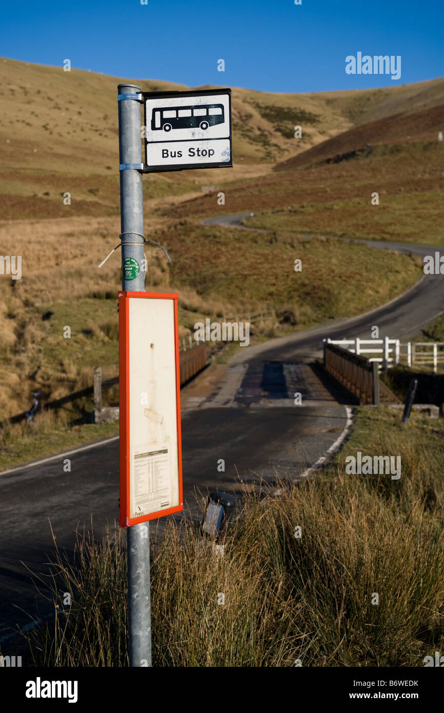 empty rroad and a remote rural bus stop sign in the Upper Elan valley powys mid wales UK Stock Photo