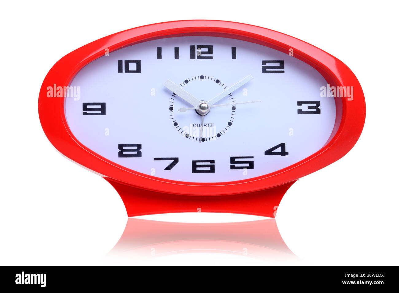 Red retro oval shaped clock cut out isolated on white background Stock Photo