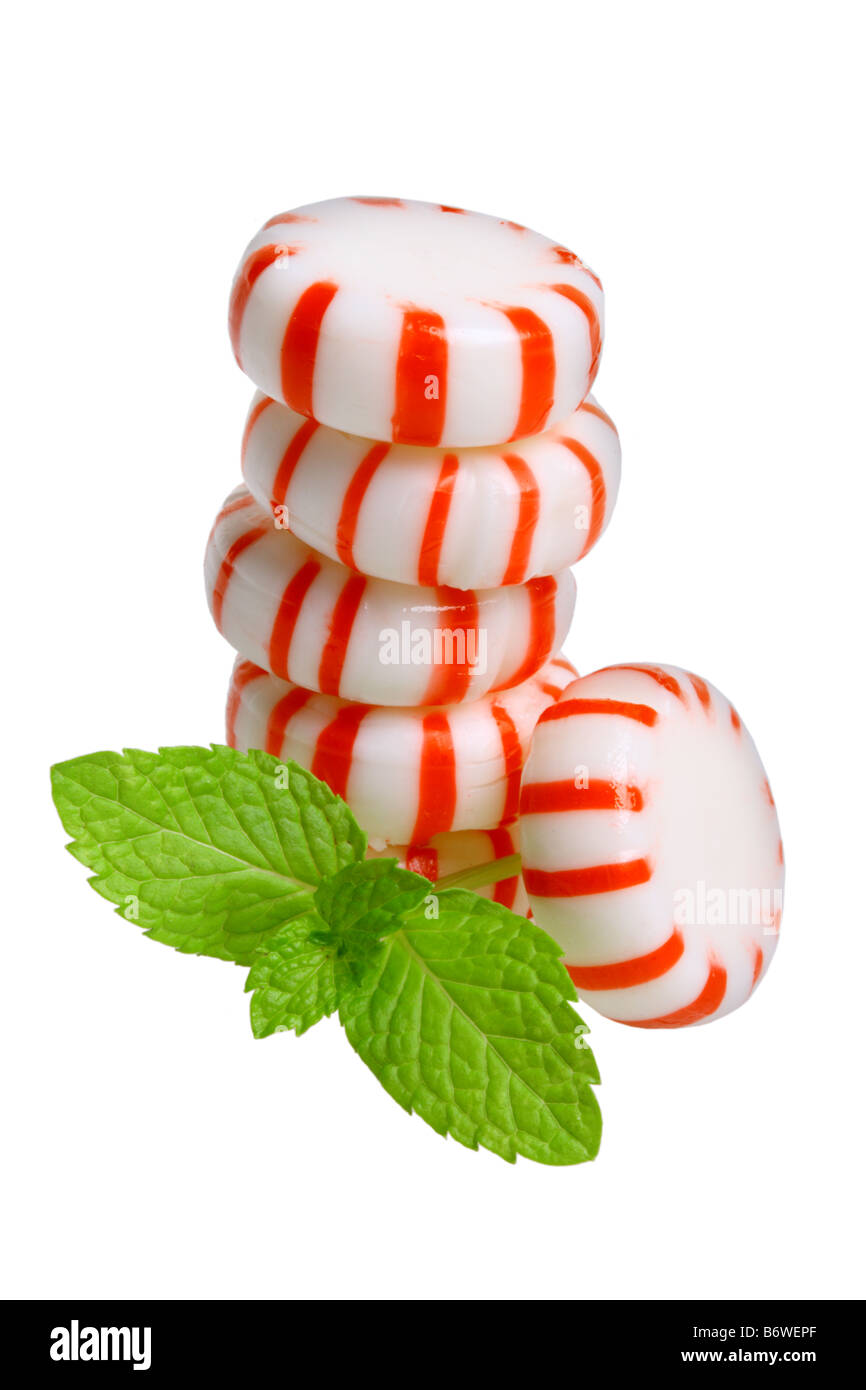 Peppermint candies and mint leaves cut out isolated on white background Stock Photo