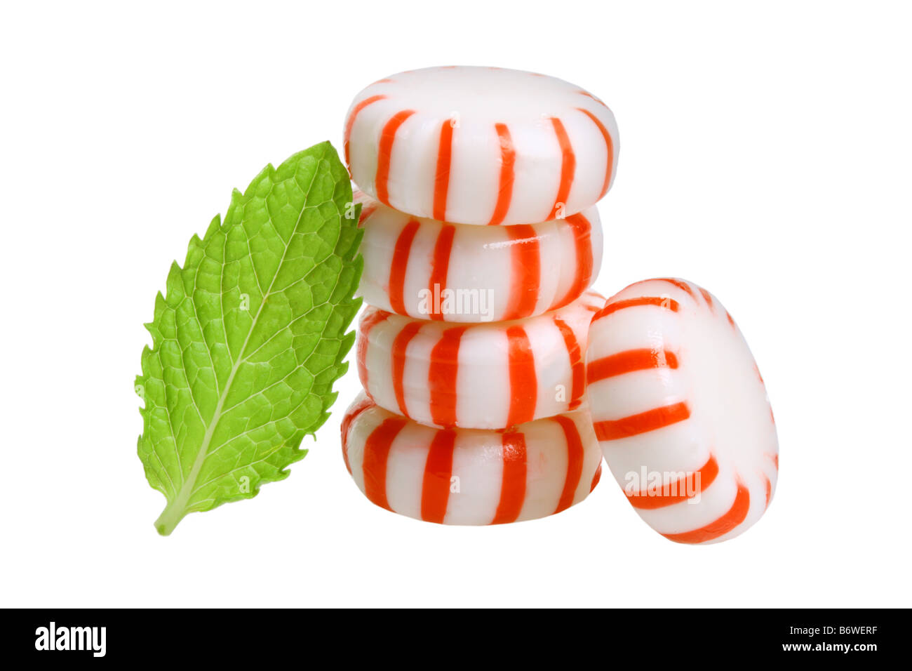 Peppermint candies and mint leaves cut out isolated on white background Stock Photo