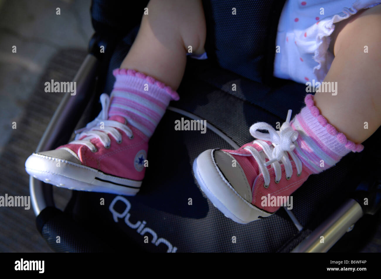 baby toddler wearing pink chuck taylors converse allstars baseball shoes Stock Photo Alamy