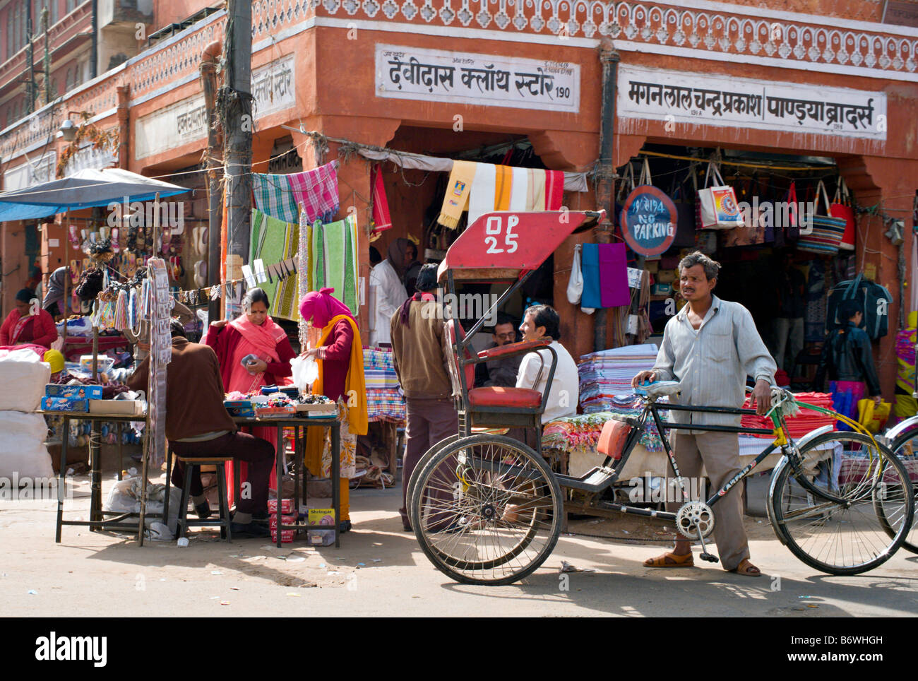 INDIA JAIPUR RAJASTHAN Bicycle rickshaw driver waits for customers on a market street in Jaipur Stock Photo