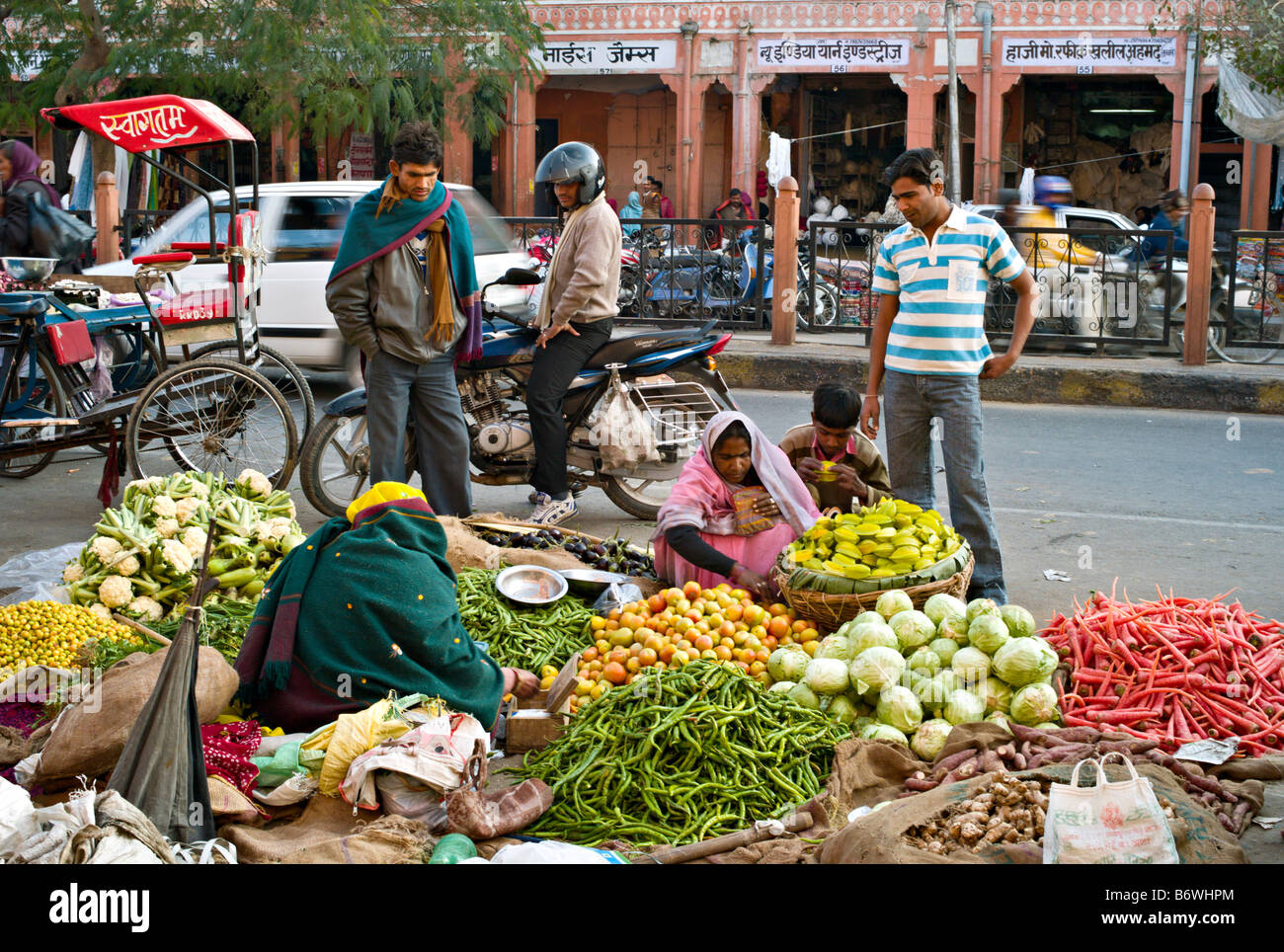 INDIA JAIPUR RAJASTHAN Colorful vegetables and fruits tended by an