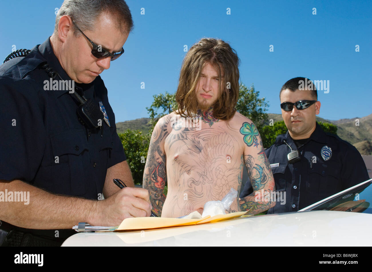 Police Officer Arresting Young Man Stock Photo - Alamy
