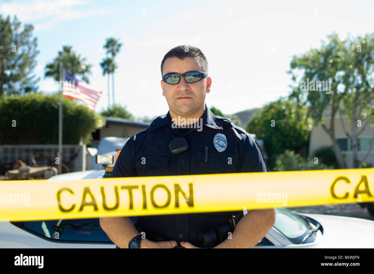 Police Officer Standing Behind Police Tape Stock Photo - Alamy