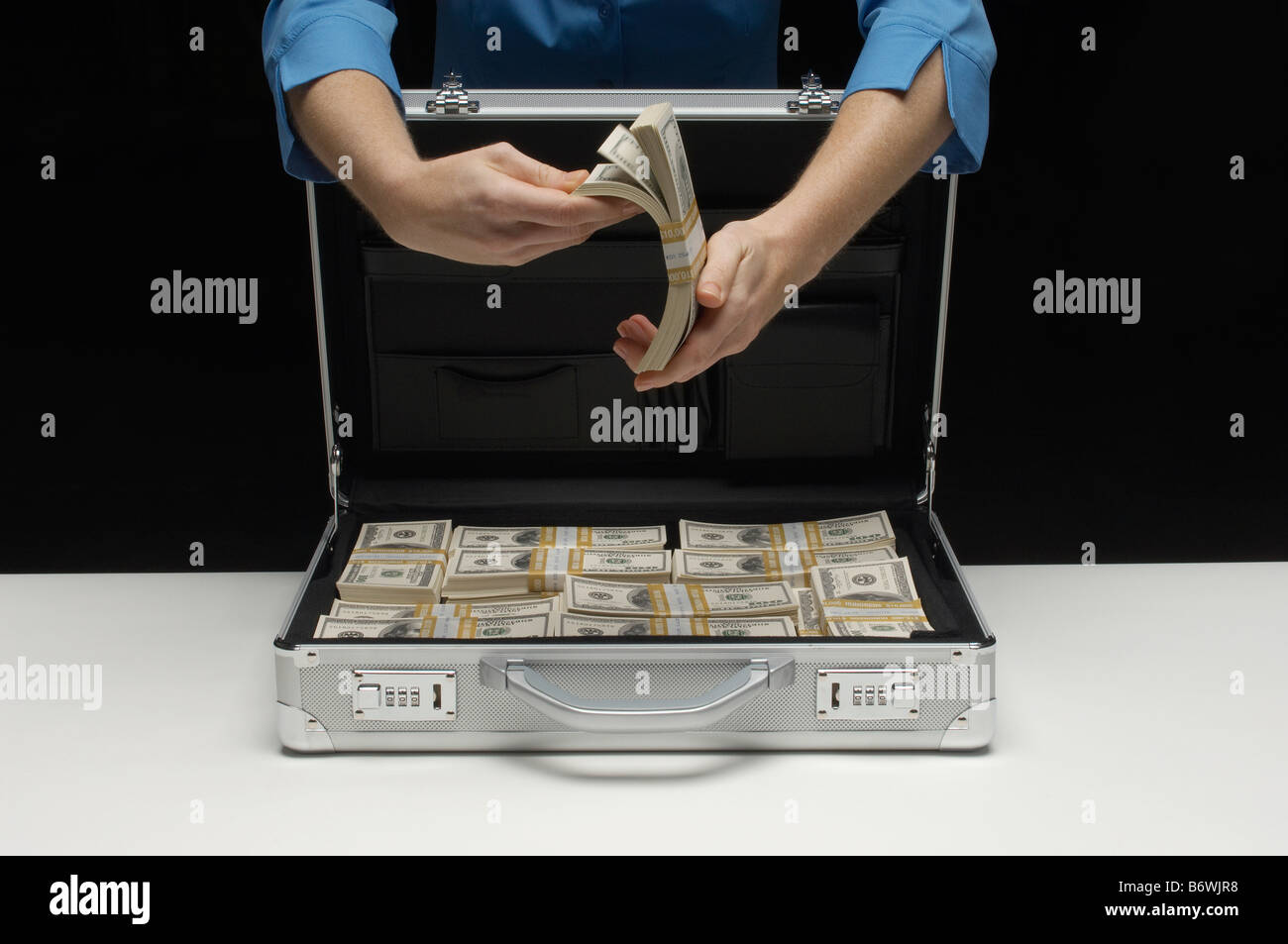 Woman briefcase full money hi-res stock photography and images - Alamy