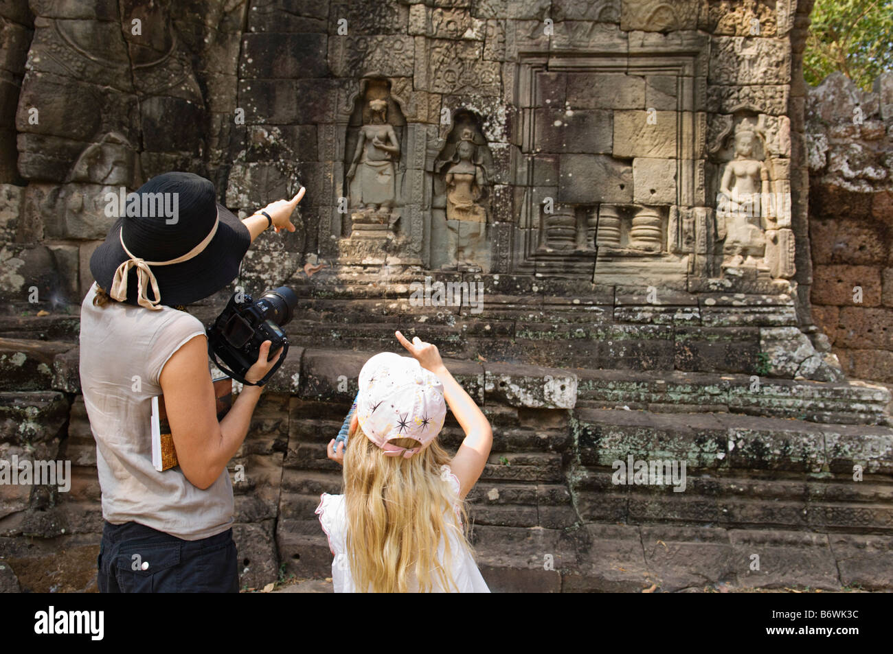 Woman and Girl Looking at Ancient Temple Stock Photo