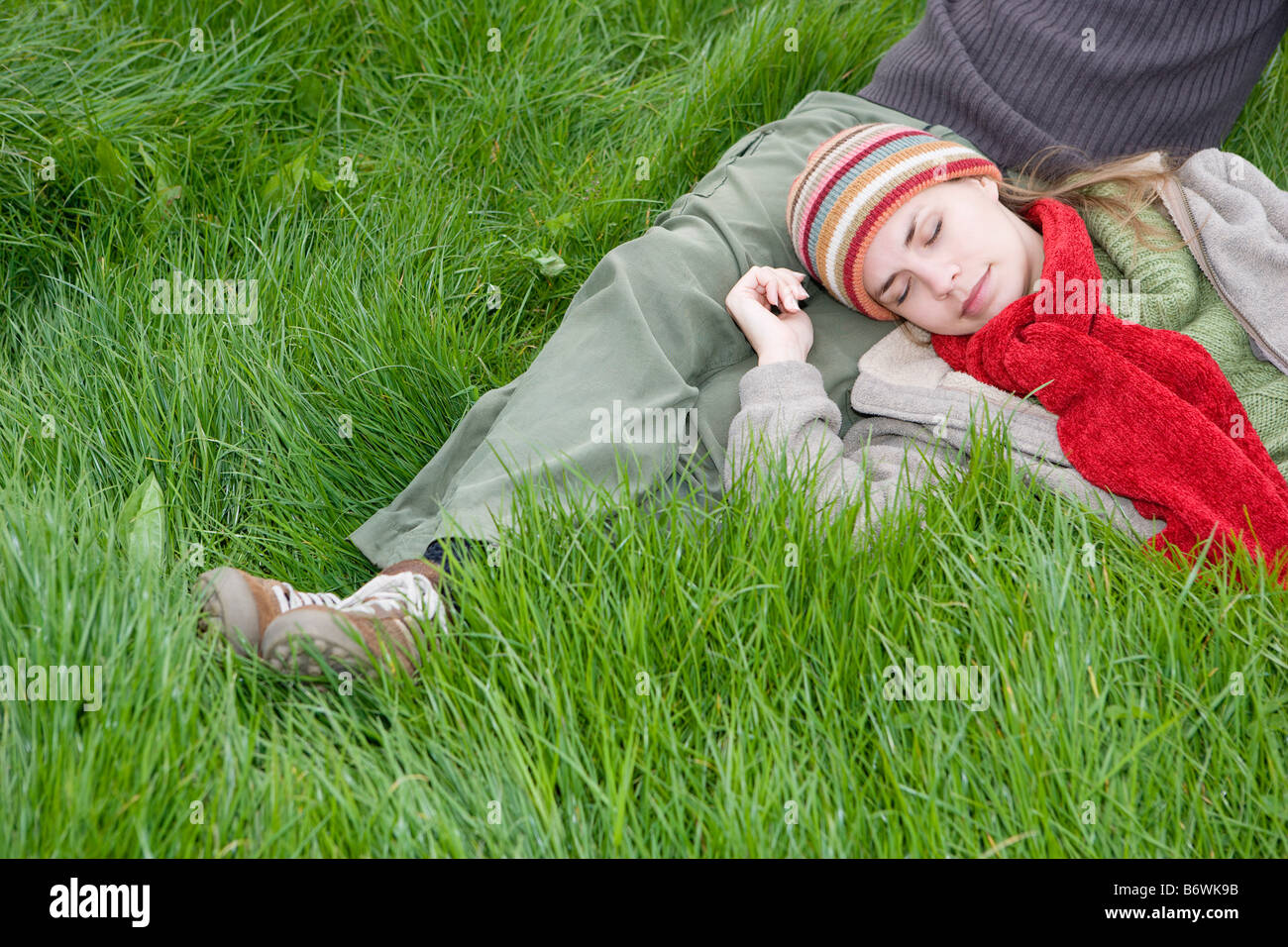 Young Couple Relaxing in the Grass Stock Photo - Alamy