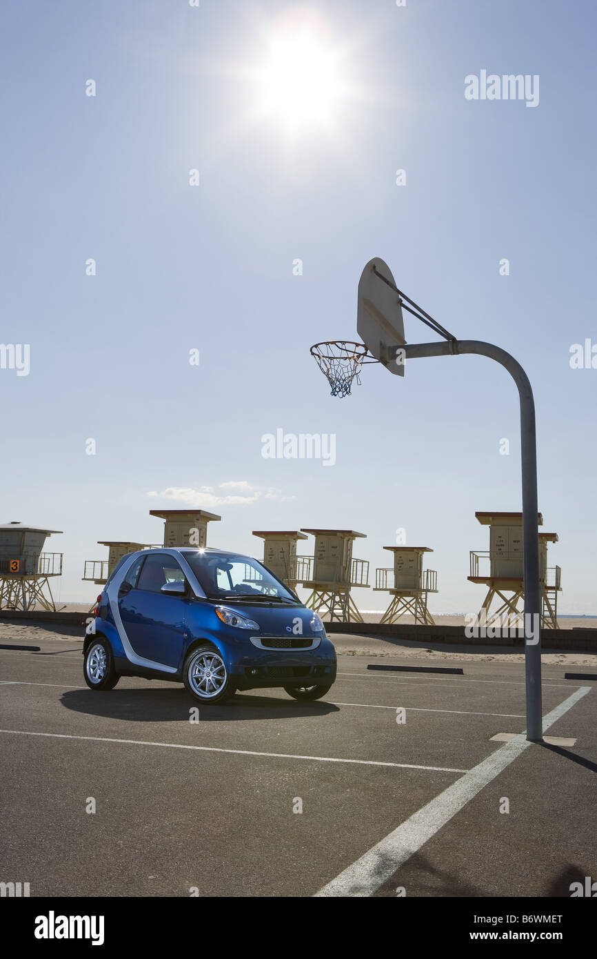 Smartcar parked on basketball court at beach Stock Photo