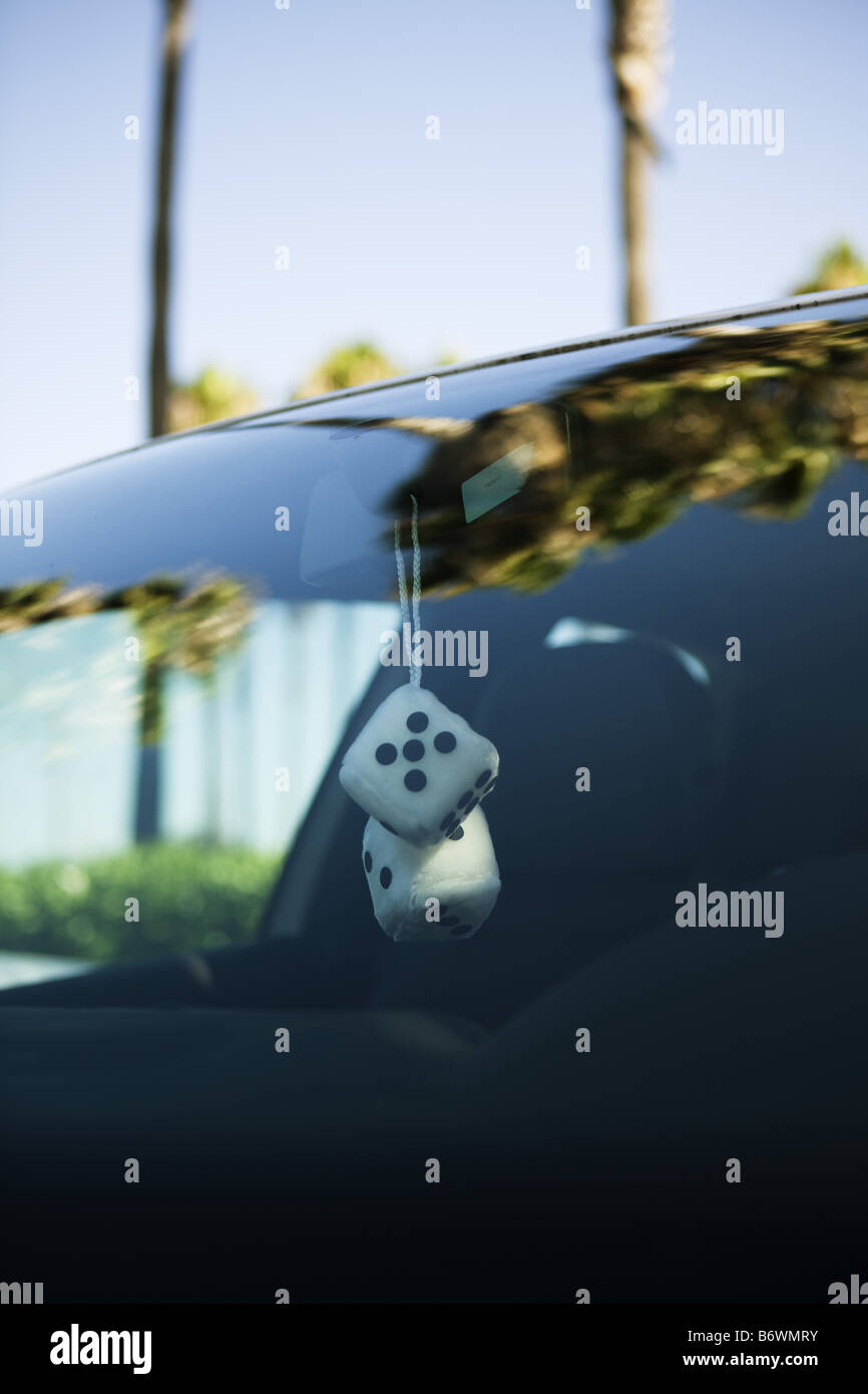 Fuzzy dice hanging from rear view mirror of car Stock Photo Alamy