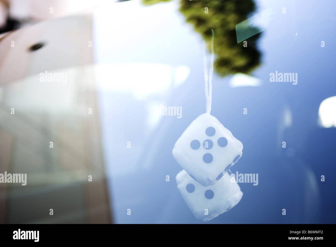 Fuzzy dice in car Stock Photo Alamy