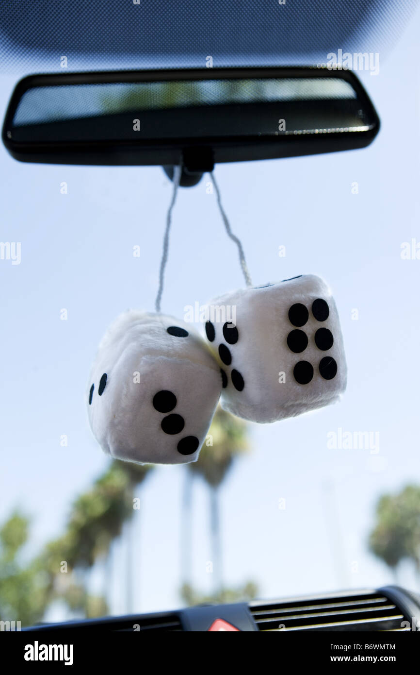 White fuzzy dice in car Stock Photo Alamy