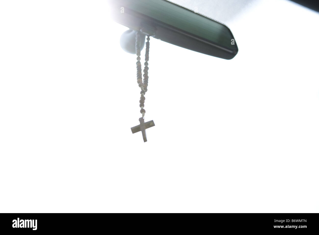 Rosary hanging from rear view mirror of car Stock Photo - Alamy